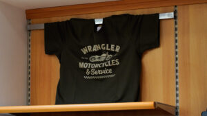 T-shirt uomo taglie comode: maglietta nera Wrangler con stampa vintage esposta in negozio.