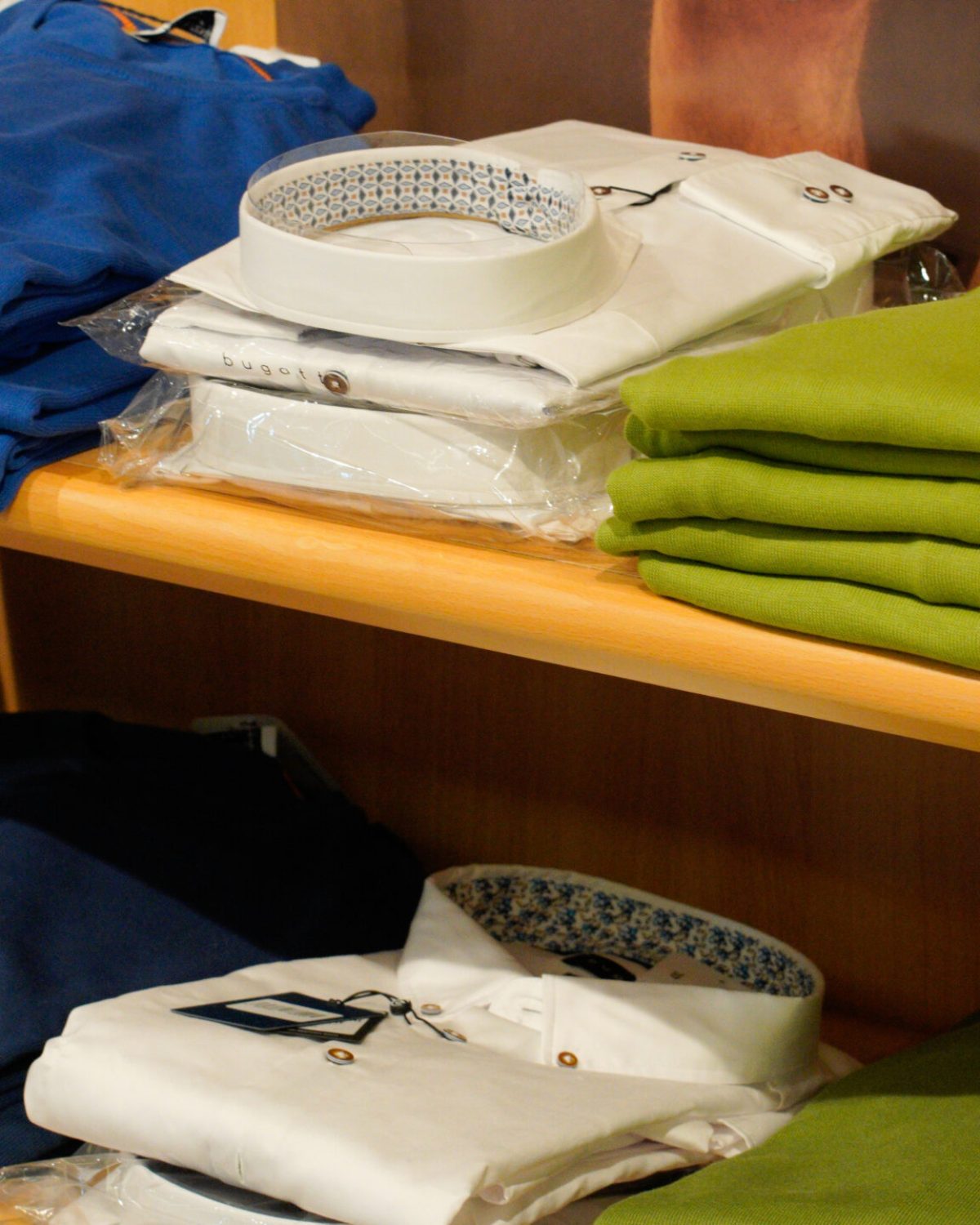 Maglieria uomo taglie comode: maglie estive e polo piegate nei toni del verde acido, bianco e blu.